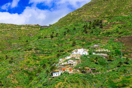 Small Village and Buildings in Green Mountains Landscape on Canary Island in Spainの写真素材