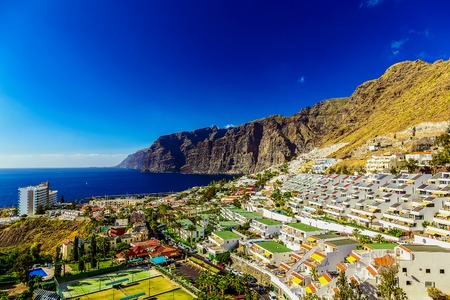 Coast or Shore of Atlantic Ocean with Buildings Landscape on Tenerife Canary Island at Dayの写真素材