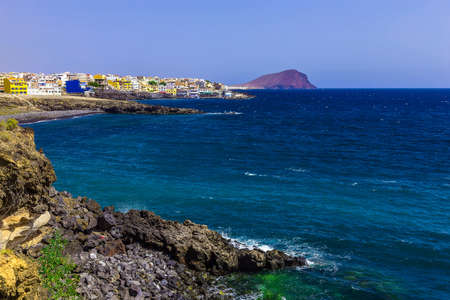 Rock Coast or Shore of Atlantic Ocean with Buildings Landscape on Tenerife Islandの写真素材