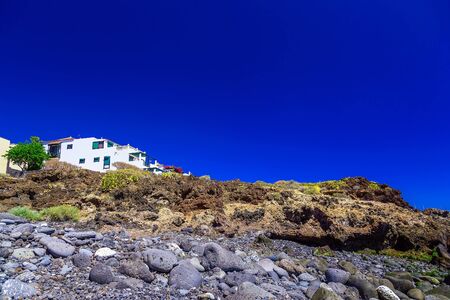 Small Village and Buildings in Rock Mountains Landscape on Tenerife Island in Spain at Dayの写真素材