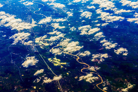 Earth and City Aerial view Above Clouds from Planeの写真素材