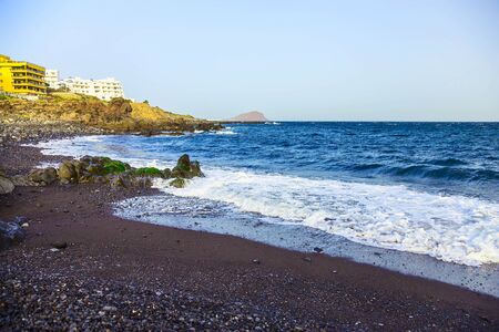 Rock Coast or Shore of Atlantic Ocean with Buildings Landscape or Seascape on Tenerife Canary Island in Spainのeditorial素材