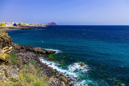 Rock Coast or Shore of Atlantic Ocean with Buildings Landscape on Canary Island in Spain at Dayの写真素材
