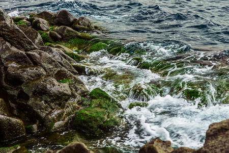 Beach Stones in Ocean or Sea Water with Waves and Foam Abstract Backgroundの写真素材
