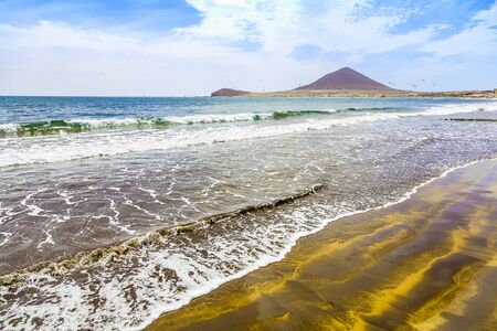 Sand Beach of Atlantic Ocean with Waves on Tenerife Canary Island in Spainの写真素材