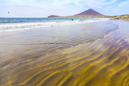 Sand Beach of Atlantic Ocean with Waves on Tenerife Canary Island in Spainの写真素材