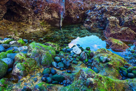 Beach Stones in Ocean or Sea Water Abstract Backgroundの写真素材