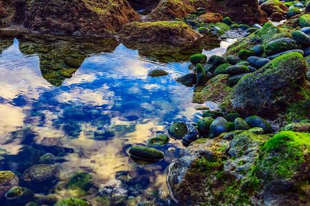 Beach Stones in Ocean or Sea Water Abstract Backgroundの写真素材