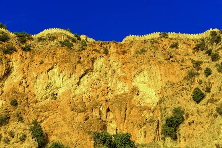 Castle wall on hill on background of blue sky in Alanya, Turkeyの写真素材