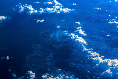 Airplane view on Ocean Coast above the Cloudsの写真素材