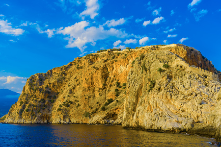 Ancient Alanya fortress on high rock by sea at sunset, Turkeyの写真素材