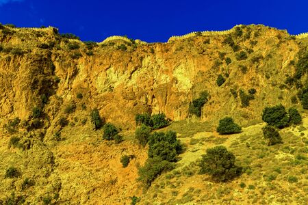 Castle wall on hill on background of blue sky in Alanya, Turkeyの写真素材