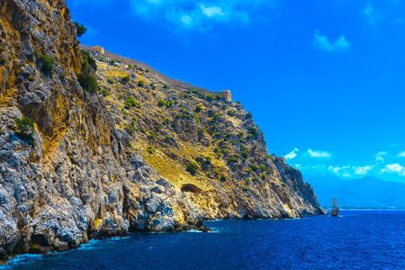 Wall of ancient fortress at rock top in Alanya at sunny day, Turkeyの写真素材