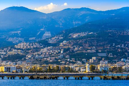 Lighthouse and long pier at the entrance to the sea port of Alanya, Turkeyの写真素材