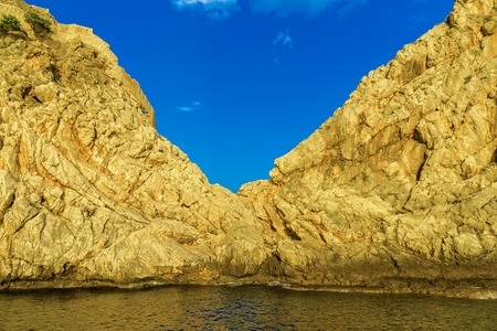 View on rocky hills among sea at sundown in Alanya, Turkeyの写真素材