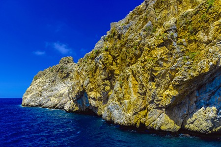View of cliffs on background of blue sky from sea at sunny day in Alanya, Turkeyの写真素材