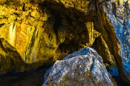 Closeup View on Rocky Mountain with Cave at Sunset over water in Alanya, Turkeyの写真素材
