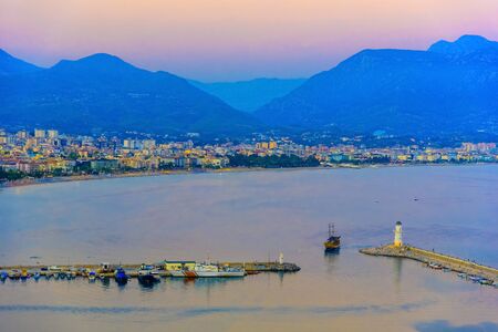 View on sea port of Alanya and lighthouses at sunset, Turkeyの写真素材