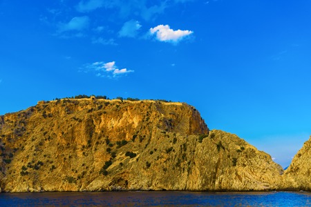 Wall of ancient fortress at rock top in Alanya at sunset, Turkeyの写真素材