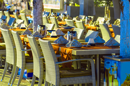 Restaurant tables and chairs on street in Alanya at sunny day, Turkeyの写真素材