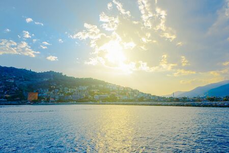 View of Alanya peninsula with Red Tower and long pier at sundown, Turkeyの写真素材
