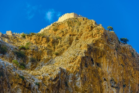 Castle wall on hill on background of blue sky in Alanya, Turkeyの写真素材