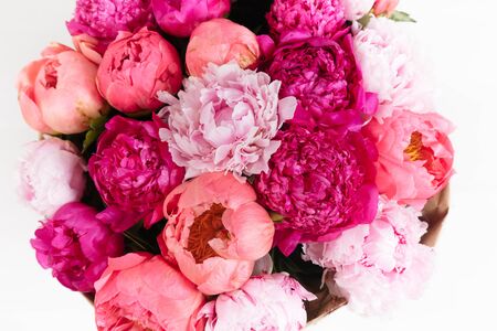 Close-up rich bunch of peonies and tea roses on white background top viewの写真素材