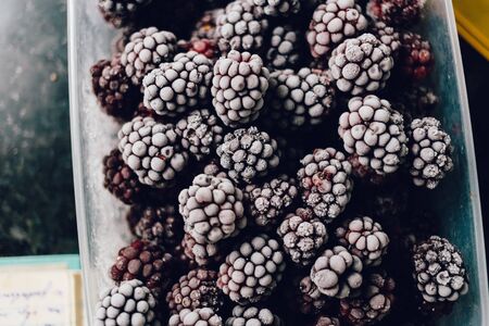 Close-up of several frozen blackberries with different shades of redの写真素材