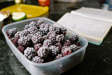 Close-up of several frozen blackberries with different shades of redの写真素材