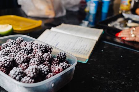 Close-up of several frozen blackberries with different shades of redの写真素材