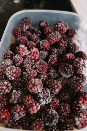 Close-up of several frozen blackberries with different shades of redの写真素材