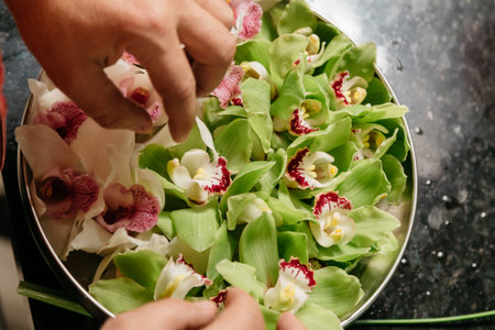 hand making white and green orchids decorationの写真素材