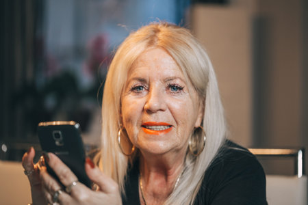 Old woman touch smartphone at home