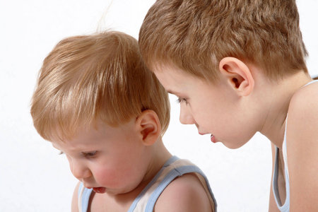 Portrait of two little boys close up on a white backgroundの写真素材