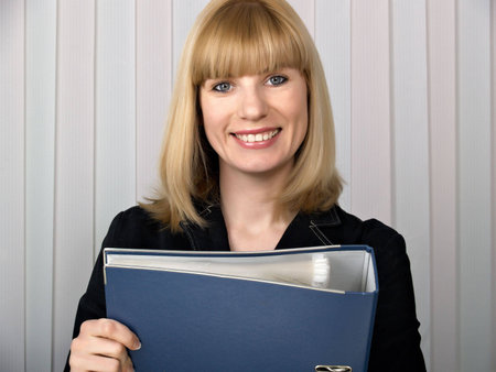 Folder for papers in hands at business of the woman in black clothes