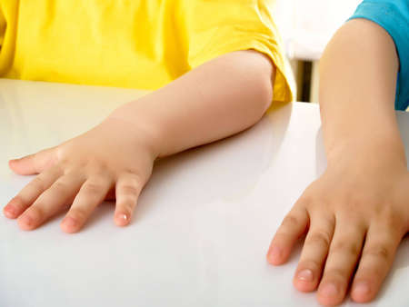 Parts of hands of two boysの写真素材