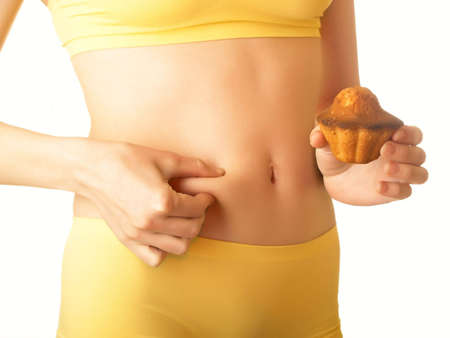 Fruitcake in a hand of the woman from a harmonous figureの写真素材