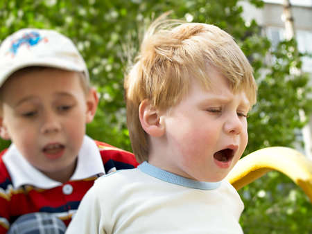 Boys play on a children's playground in the springの写真素材