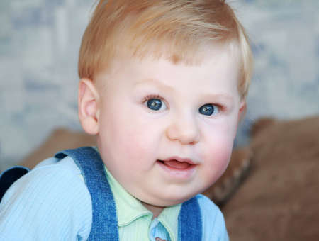 The small smiling boy looks directly in the chamberの写真素材