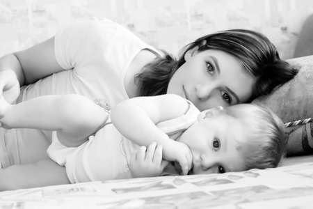 Portrait of young beautiful mum with the little boyの写真素材