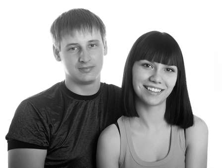 Portrait of young happy pair on a white backgroundの写真素材