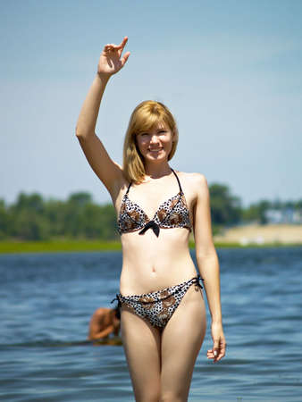 The young woman in a bathing suit on a background of the riverの写真素材