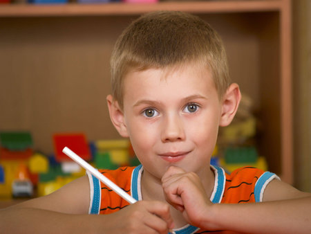 The boy of 7 years is engaged in a children's room