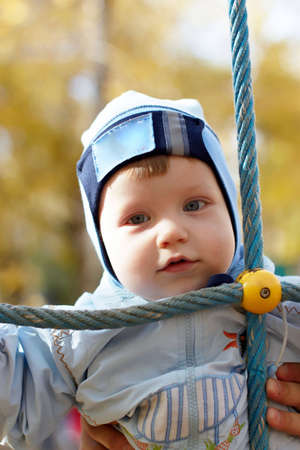 The little boy in park in the autumnの写真素材