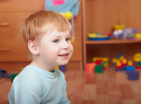 Portrait of the little boy in a children's room