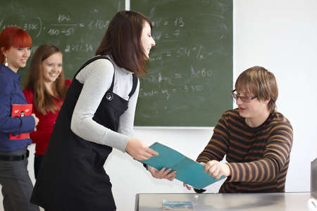 Employment at students in the higher school near a blackboardの写真素材