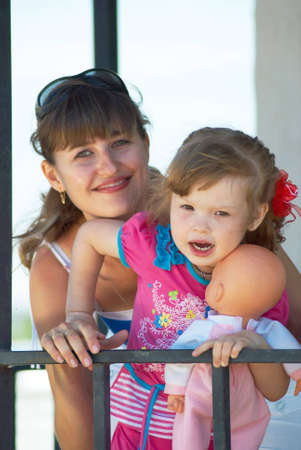 Mum With the daughter on backgroundの写真素材