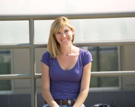 Portrait of a smiling student in the streetの写真素材