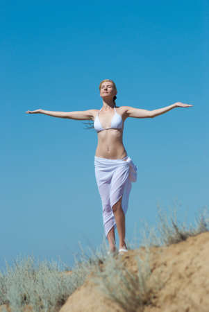 The girl in a bathing suit on a background of the dark blue skyの写真素材