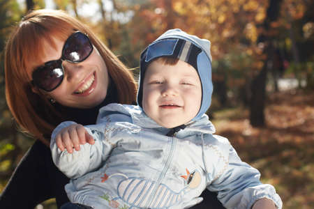 Baby boy with mother play in parkの写真素材